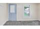 Entryway with a blue door, gray carpet, and natural light, offering a welcoming entrance to the home at 1626 W Park Ave, Albemarle, NC 28001