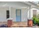 Charming covered front porch with brick accents and a bright blue door, enhancing curb appeal at 1626 W Park Ave, Albemarle, NC 28001