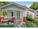 Charming home with a covered front porch featuring brick pillars and a light blue door at 1626 W Park Ave, Albemarle, NC 28001