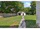 Exterior view of detached garage with a driveway and lawn at 1626 W Park Ave, Albemarle, NC 28001