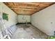 The garage interior features concrete walls, wood ceiling, concrete floor, and small window at 1626 W Park Ave, Albemarle, NC 28001