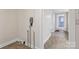 Functional hallway with tiled floors, neutral walls, and access to multiple rooms at 1626 W Park Ave, Albemarle, NC 28001