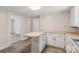 Functional kitchen layout with white cabinetry, light countertops, and convenient breakfast bar area at 1626 W Park Ave, Albemarle, NC 28001