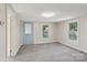 Inviting living room with neutral walls, gray carpet, and ample natural light streaming in from windows and door at 1626 W Park Ave, Albemarle, NC 28001