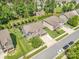 Aerial view showcasing the home, well-manicured lawn, mature trees, and neighborhood playground at 183 Canoe Pole Ln, Mooresville, NC 28117