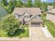 Beautiful home featuring stone accents, a well-manicured lawn, and an attached two-car garage at 183 Canoe Pole Ln, Mooresville, NC 28117
