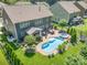 Aerial shot of a backyard showcasing the pool, spa, patio, and landscaping of this luxury home at 183 Canoe Pole Ln, Mooresville, NC 28117