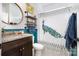 Charming bathroom with granite vanity, decorative shelves, and peacock-themed shower curtain at 183 Canoe Pole Ln, Mooresville, NC 28117