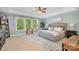 Bright bedroom featuring a tray ceiling, large window, and neutral color palette at 183 Canoe Pole Ln, Mooresville, NC 28117