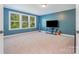 Blue bedroom featuring a large window providing natural light and a wall-mounted television with furniture at 183 Canoe Pole Ln, Mooresville, NC 28117