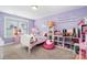 bedroom featuring purple walls, a white bed frame, and shelves with a variety of toys at 183 Canoe Pole Ln, Mooresville, NC 28117