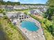 Aerial view of a community pool surrounded by sun loungers, tables, and chairs, and a beautiful neighborhood at 183 Canoe Pole Ln, Mooresville, NC 28117