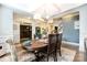 Dining room featuring coffered ceilings, wood floors, stylish lighting, and access to an office at 183 Canoe Pole Ln, Mooresville, NC 28117