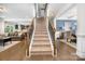 Welcoming entryway with hardwood floors, a carpeted staircase, and views into the living and dining areas at 183 Canoe Pole Ln, Mooresville, NC 28117