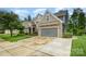 Attractive home featuring stone accents, a large driveway, and a well-manicured front lawn at 183 Canoe Pole Ln, Mooresville, NC 28117