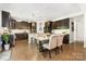 Kitchen with stainless steel appliances, dark wood cabinetry, a center island, and a view to the dining area at 183 Canoe Pole Ln, Mooresville, NC 28117