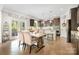 Dining area with an island kitchen, granite countertops, stainless steel appliances and backyard views at 183 Canoe Pole Ln, Mooresville, NC 28117