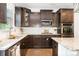 Modern kitchen features dark wood cabinetry, stainless steel appliances, and granite countertops at 183 Canoe Pole Ln, Mooresville, NC 28117