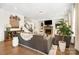 Cozy living room with a stone fireplace, a TV, a staircase, and comfortable sofas and armchairs at 183 Canoe Pole Ln, Mooresville, NC 28117