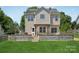 Exterior rear of the property featuring a large backyard with a wooden deck and manicured lawn at 1986 Trace Creek Dr, Waxhaw, NC 28173