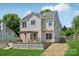 Two-story home featuring a wooden deck with pergola, lush greenery, and well-maintained lawn at 1986 Trace Creek Dr, Waxhaw, NC 28173