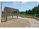 Outdoor patio area features a wooden pergola, a graveled area and green backyard space at 1986 Trace Creek Dr, Waxhaw, NC 28173