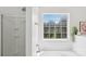 An airy bathroom shows a window, a shower, and a large tub with bright lighting at 1986 Trace Creek Dr, Waxhaw, NC 28173