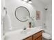 A stylish bathroom features a modern mirror, vanity and a shower-tub combo at 1986 Trace Creek Dr, Waxhaw, NC 28173