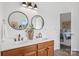 A stylish bathroom features a dual sink vanity, modern mirrors and bright lighting at 1986 Trace Creek Dr, Waxhaw, NC 28173