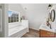 A bright bathroom boasts natural light, a white tub and a dual sink vanity at 1986 Trace Creek Dr, Waxhaw, NC 28173