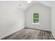 Bright, airy bedroom with wood-look floors, a ceiling fan, and a window with a view at 1986 Trace Creek Dr, Waxhaw, NC 28173
