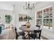 Sunlit dining area featuring hardwood floors, modern chandelier, and view of backyard at 1986 Trace Creek Dr, Waxhaw, NC 28173