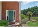 Inviting front entrance featuring a green door, brick facade, and manicured landscaping at 1986 Trace Creek Dr, Waxhaw, NC 28173