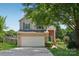 Charming two-story home featuring a two-car garage, green front door, and well-maintained landscaping at 1986 Trace Creek Dr, Waxhaw, NC 28173