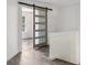 Hallway featuring a sliding barn door leading to a bedroom with a window at 1986 Trace Creek Dr, Waxhaw, NC 28173