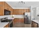 Spacious kitchen with stainless steel appliances, wood cabinets and white countertops at 1986 Trace Creek Dr, Waxhaw, NC 28173