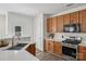 Well-lit kitchen featuring stainless steel appliances, wood cabinets and white countertops at 1986 Trace Creek Dr, Waxhaw, NC 28173