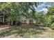 View of the backyard with many leafy green trees and grass at 2001 Enderbury Dr, Indian Trail, NC 28079