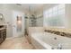 Bathroom showcasing a glass shower, soaking tub, and tiled floor at 2001 Enderbury Dr, Indian Trail, NC 28079