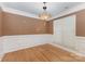 Elegant dining room with hardwood floors, wainscoting, and a decorative chandelier at 2001 Enderbury Dr, Indian Trail, NC 28079