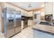 Stainless steel appliances, cream cabinetry, tile backsplash, and an open doorway at 2001 Enderbury Dr, Indian Trail, NC 28079