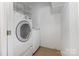 Compact laundry area featuring a white washer and dryer and neutral tile floors at 2001 Enderbury Dr, Indian Trail, NC 28079