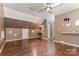 Spacious living room with hardwood flooring, built-in shelving, and a ceiling fan at 2001 Enderbury Dr, Indian Trail, NC 28079
