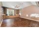 Living room with built-in shelving and seating, hardwood floors, and a large window at 2001 Enderbury Dr, Indian Trail, NC 28079