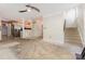 Open-concept living area with a staircase to the right and a kitchen area in the background at 2001 Enderbury Dr, Indian Trail, NC 28079
