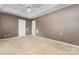 Large main bedroom with neutral carpet, fresh paint, a ceiling fan, and two white doors at 2001 Enderbury Dr, Indian Trail, NC 28079