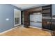 Bedroom with a built-in desk, shelves, hardwood floors, and a large window at 2001 Enderbury Dr, Indian Trail, NC 28079