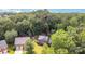 An aerial view of a brick house nestled among lush, mature trees and landscaping, providing enhanced privacy at 205 Rosedale Ln, Matthews, NC 28105