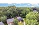 Aerial view of a home with mature trees, showcasing the roof and manicured lawn that enhance curb appeal at 205 Rosedale Ln, Matthews, NC 28105