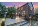 Exterior view showcasing a multi-level deck in the backyard of a brick home at sunset at 205 Rosedale Ln, Matthews, NC 28105